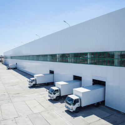 Large distribution warehouse loading dock with trucks outside